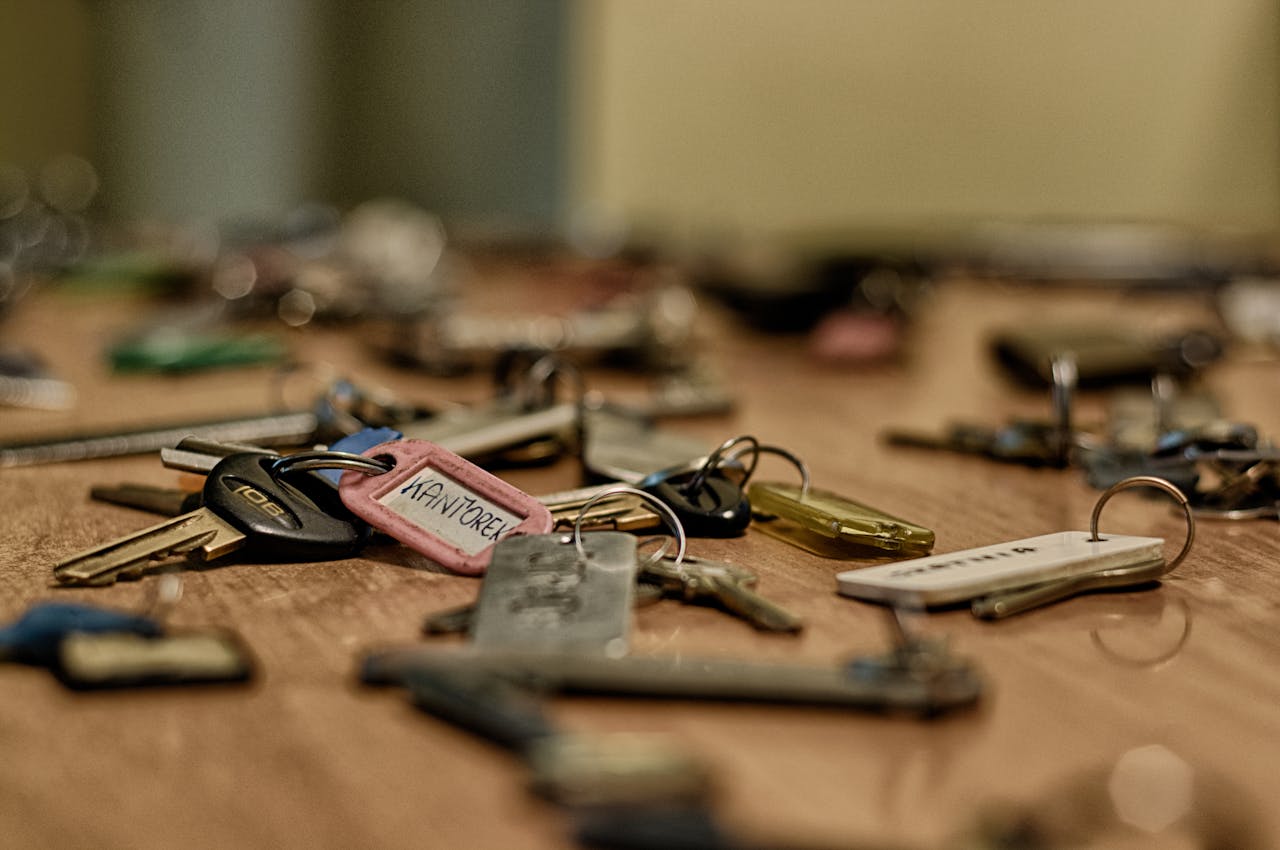 gallery-03 Macro shot of various metallic keys scattered on a wooden surface.