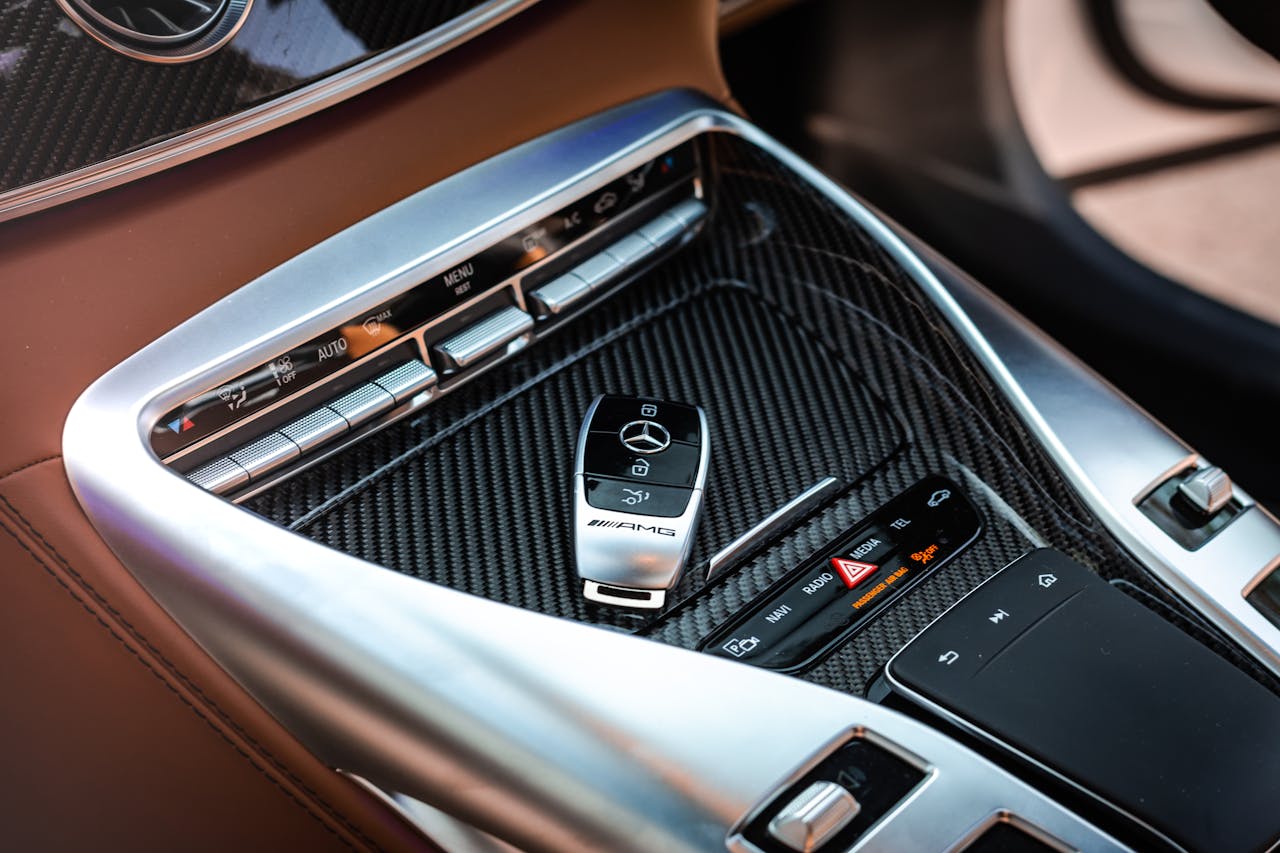 Crafting Captivating Headlines: Your awesome post title goes here Close-up view of a luxury car's control panel featuring carbon fiber and chrome details with a key fob.